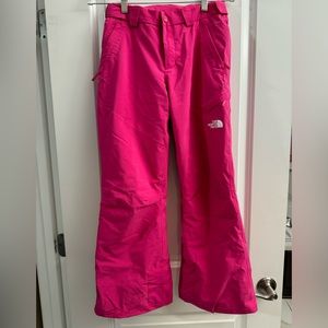 Girls hot pink North Face insulated snow pants with Velcro sides for adjustment.